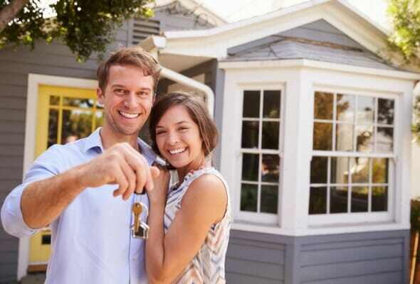 couple-with-keys-standing-outside-new-home-picture-id640228744
